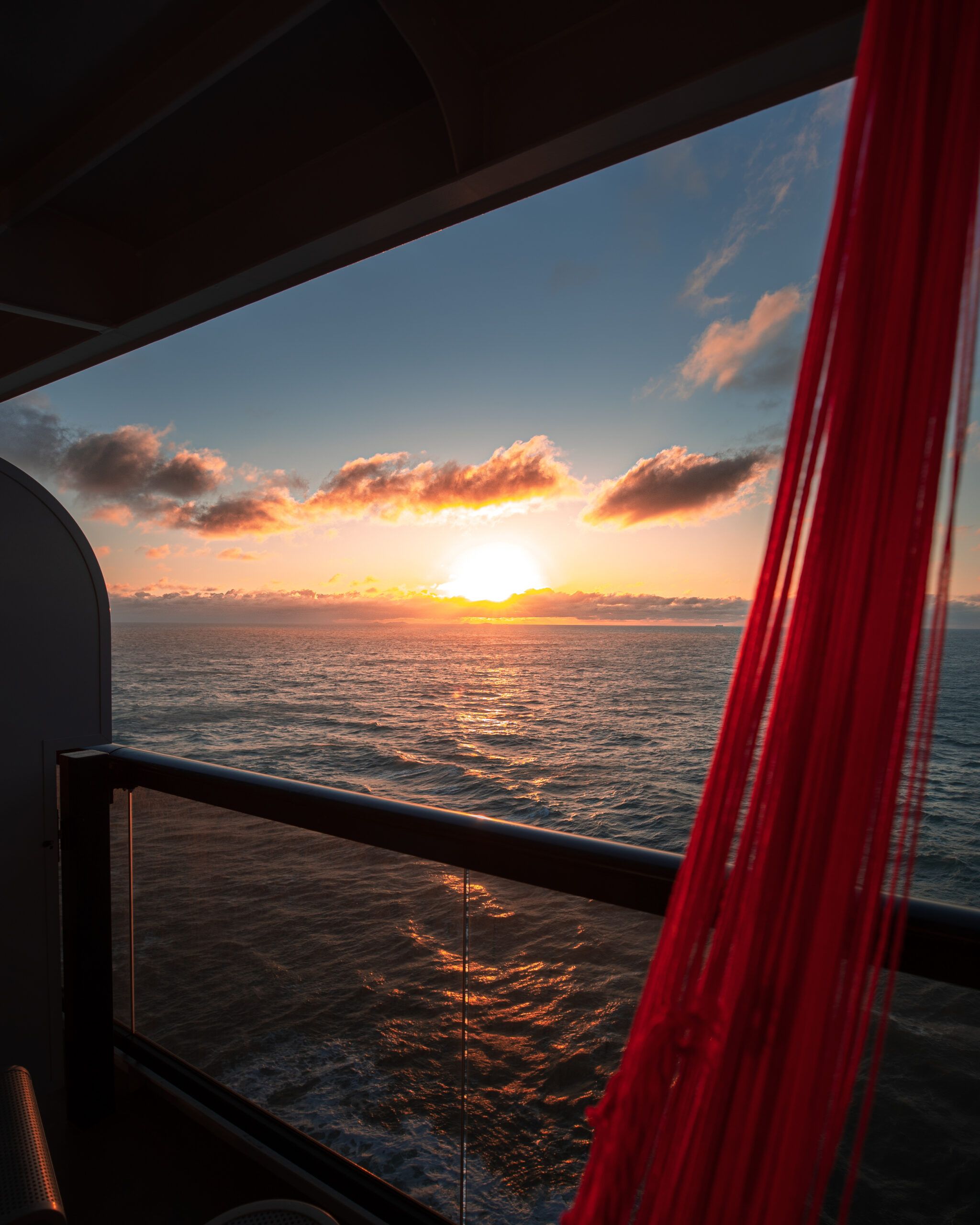 Virgin Voyages balcony sunset with red hammock