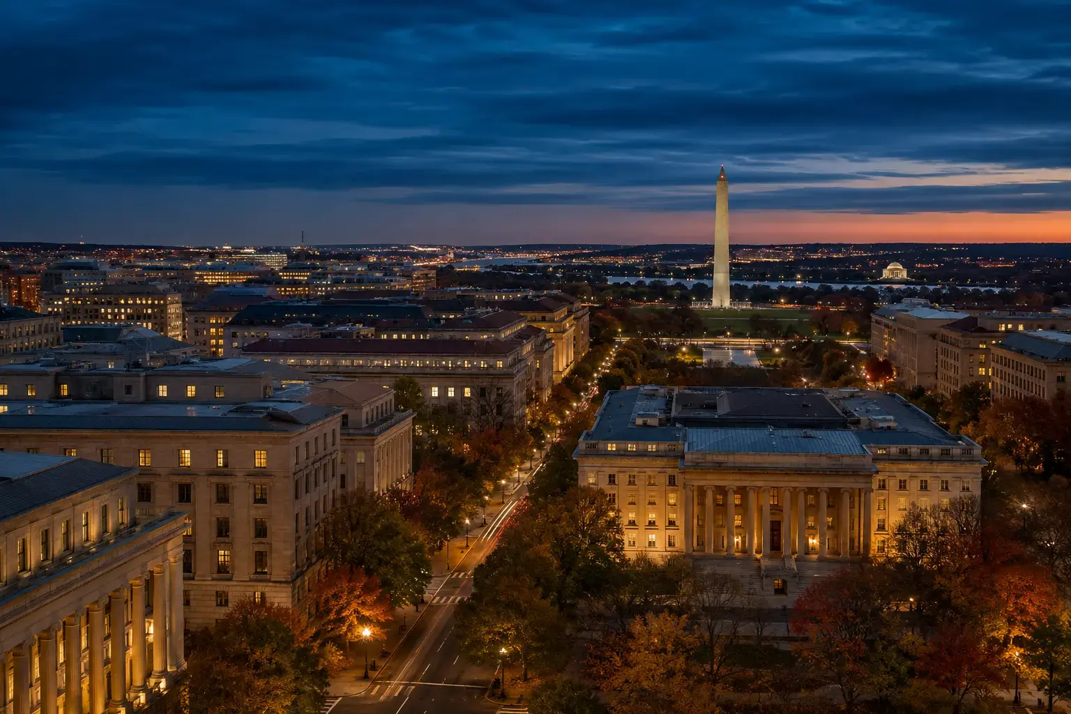Washington’s Federal Triangle and National Mall at blue hour with the Washington Monument beyond.