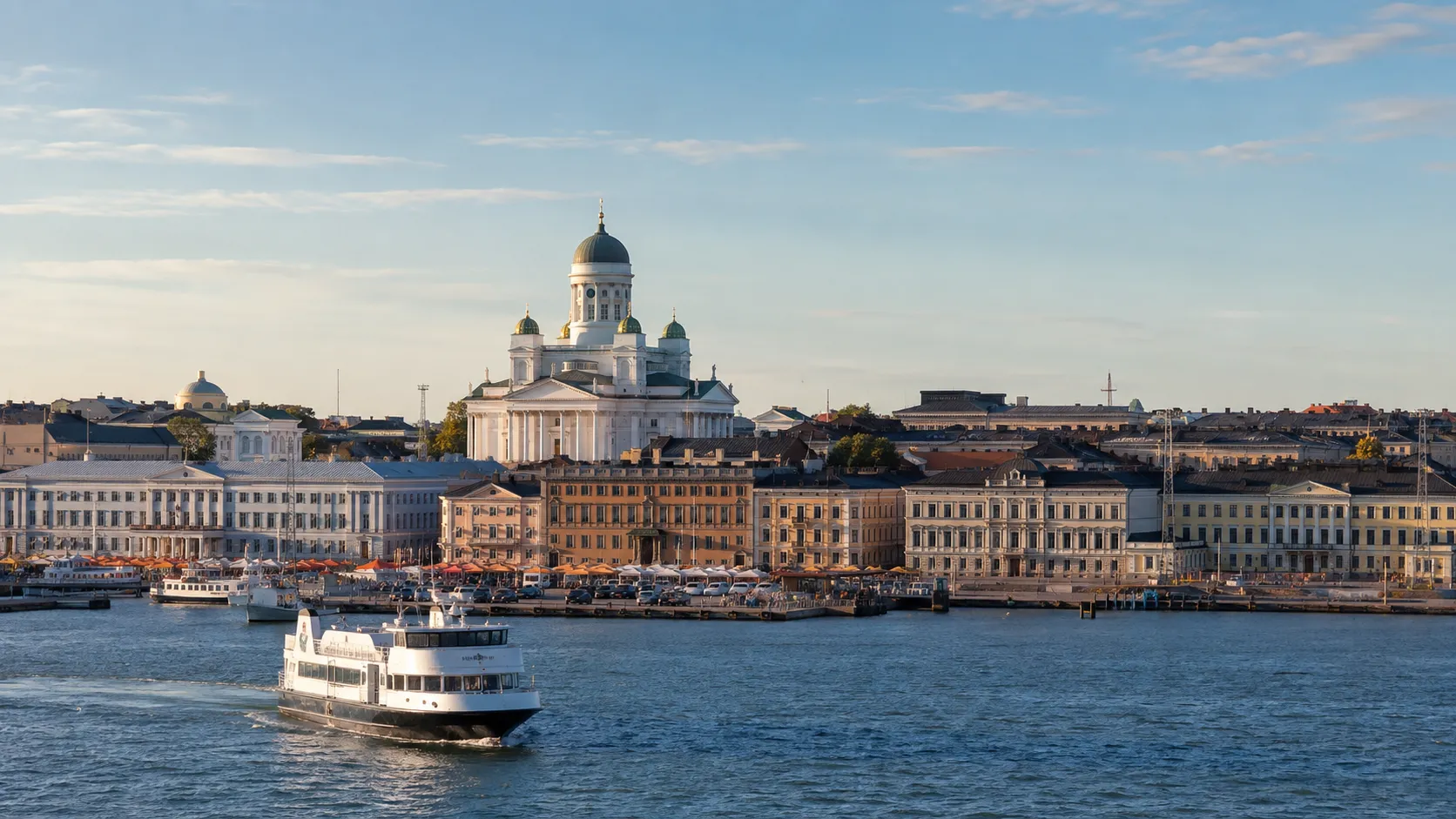 Helsinki Cathedral and Market Square seen across the harbor with a ferry in the foreground.