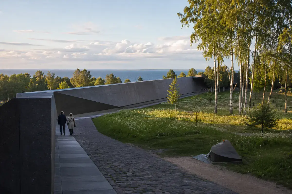 Visitors walking through Tallinn’s Maarjamäe memorial landscape above the Baltic.