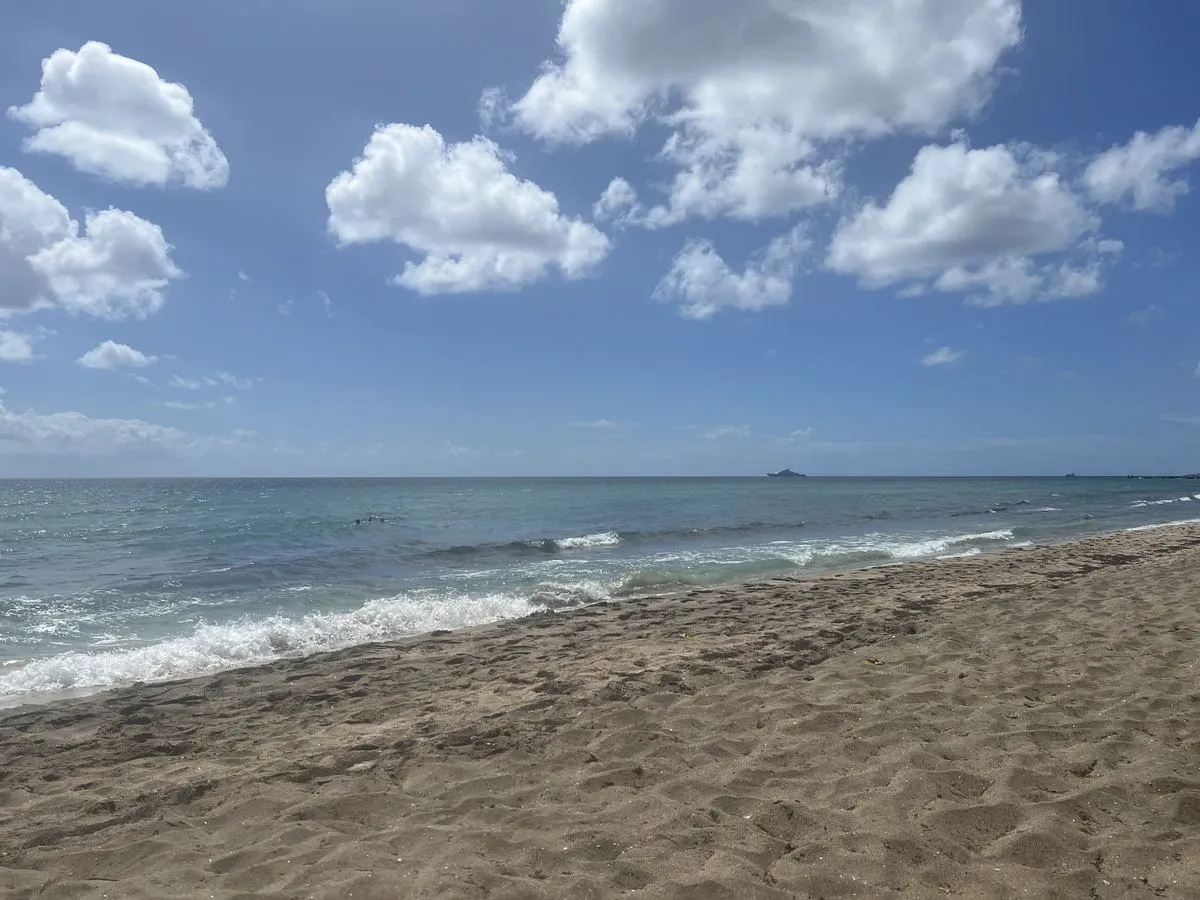 Calm blue water and a relaxed sandy shoreline at South Friars Bay on the Caribbean side of St. Kitts.