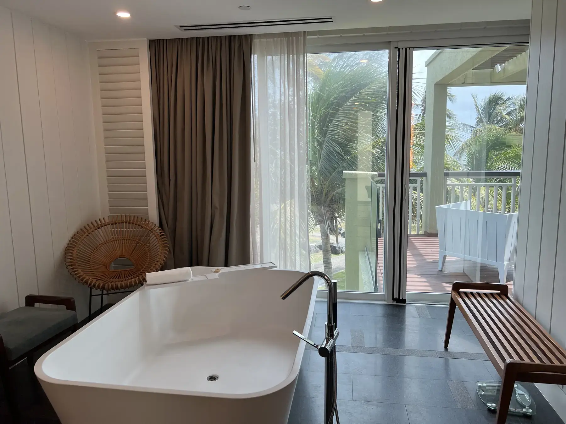 Freestanding soaking tub beside a terrace in a Park Hyatt St. Kitts bathroom