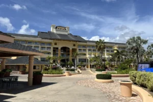 St. Kitts Marriott Beach Resort, Casino & Spa with palms and poolside grounds under a blue sky