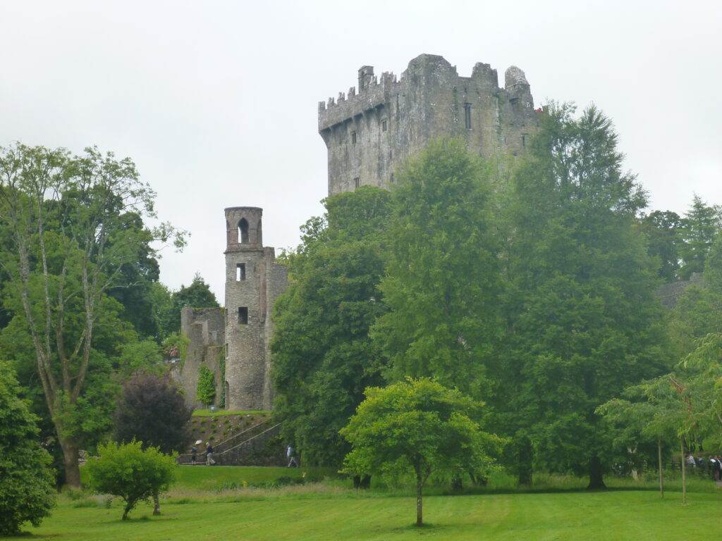 Blarney Castle rising above trees and lawns in County Cork, Ireland