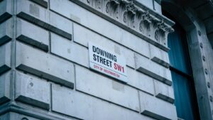 Downing Street SW1 street sign on a stone building in Westminster, London.