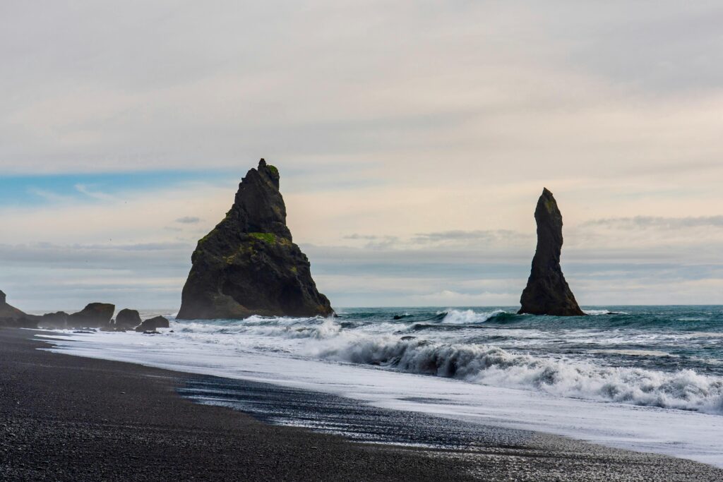 Reynisdrangar sea stacks and surf at Reynisfjara black-sand beach, Iceland