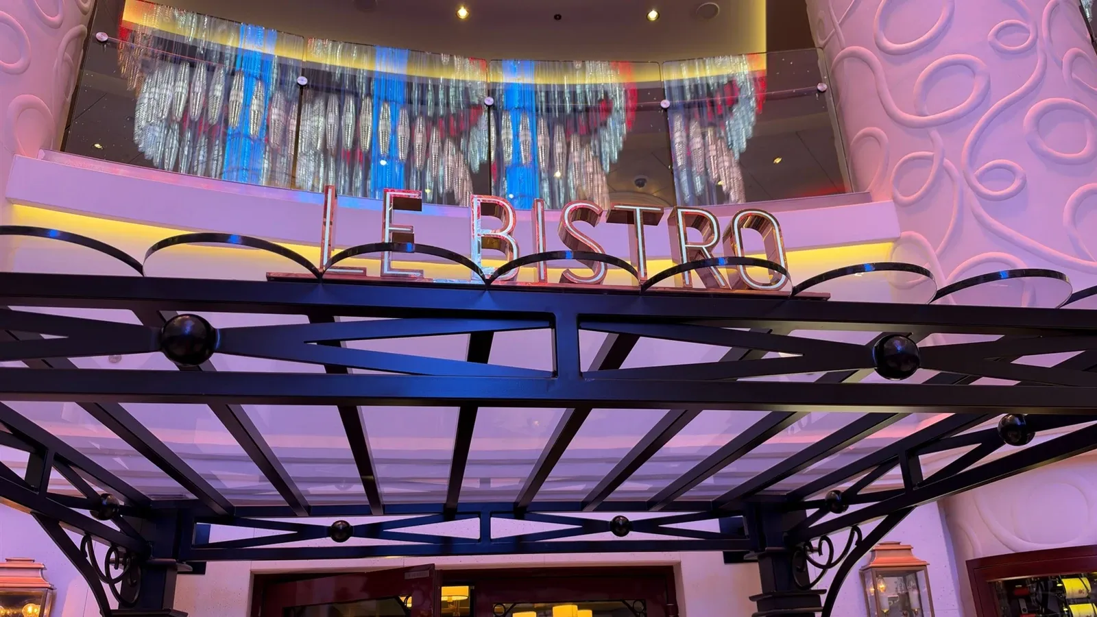 The Le Bistro entrance and colorful chandelier aboard Norwegian Getaway.