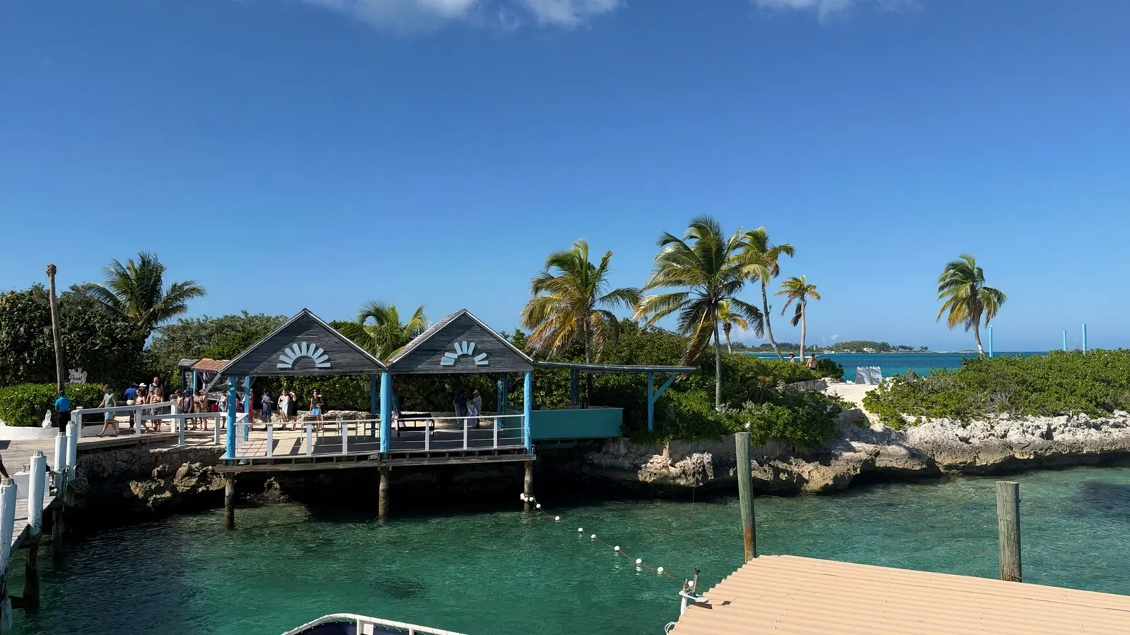 The landing pavilion and palm trees beside clear turquoise water at Pearl Island.