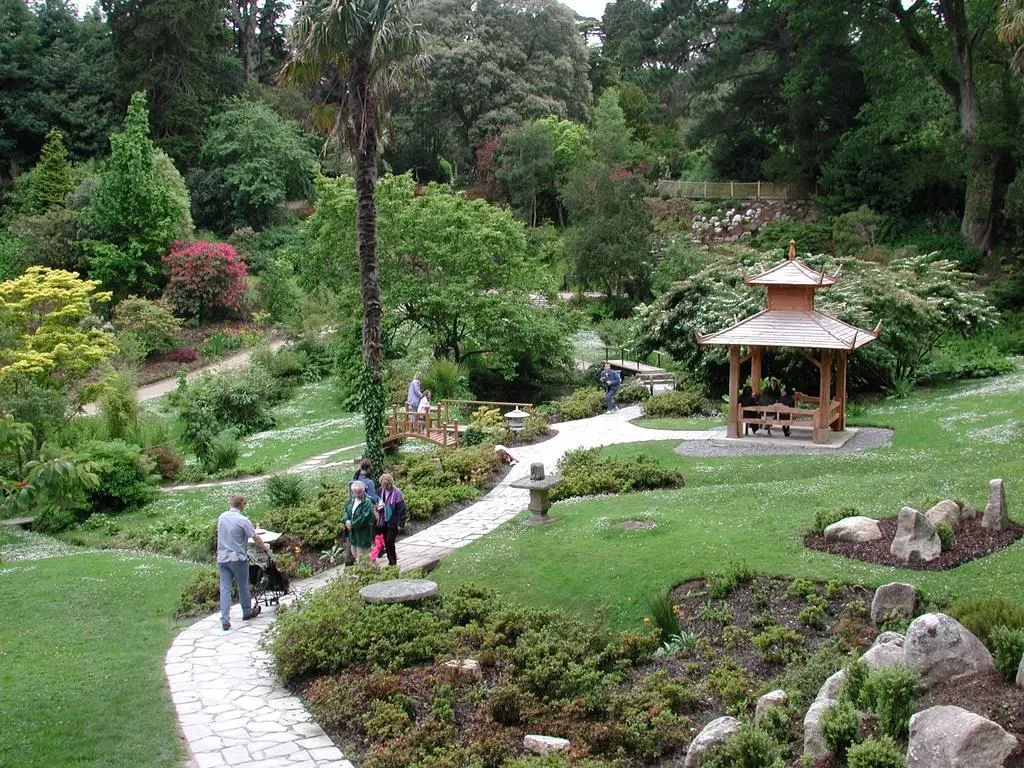 A stone bridge and lush planting in the Japanese Garden at Powerscourt Estate, Ireland