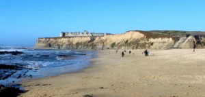 The Ritz-Carlton, Half Moon Bay on a bluff above a sandy beach and the Pacific Ocean.