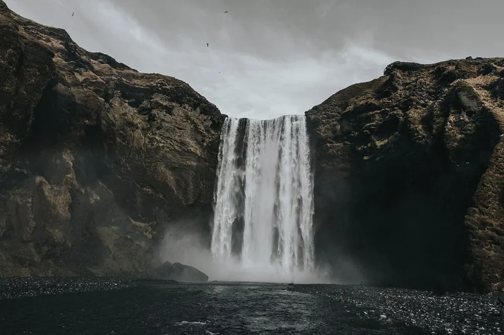 Skógafoss waterfall tumbling over dark cliffs on Iceland’s south coast